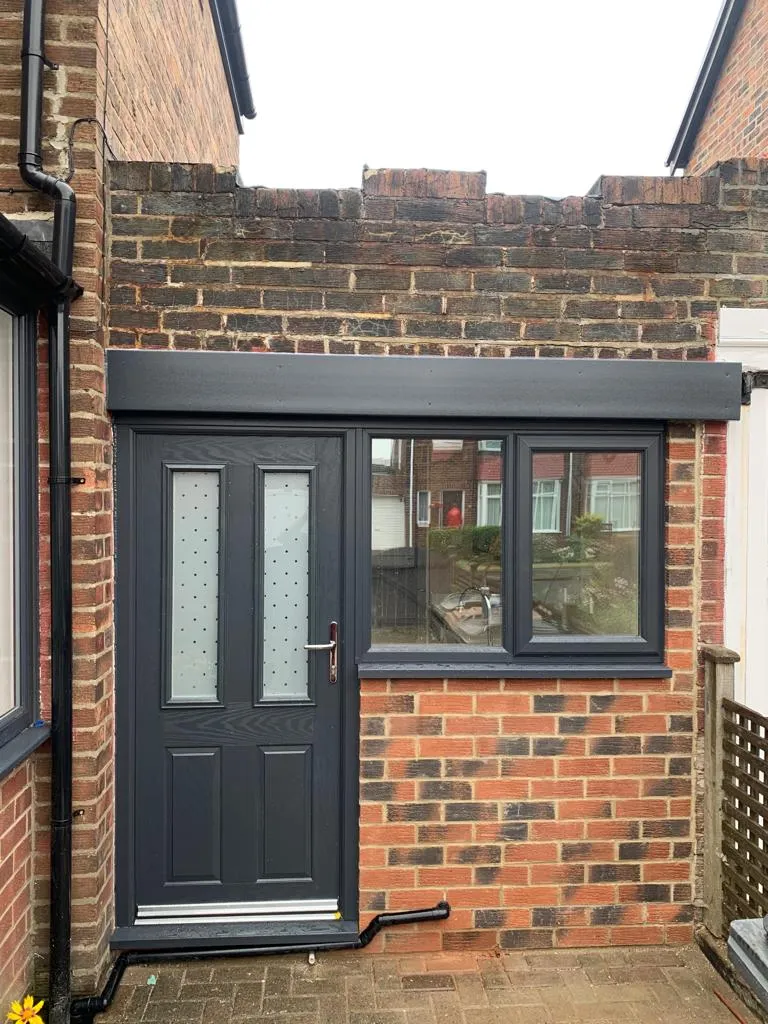 Completed garage conversion exterior with anthracite composite door, new window and brick infill
